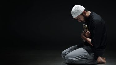 Religious asian muslim man holding holy quran