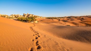 Human footprints in a sandy desert in Abu Dhabi, United Arab Emirates.