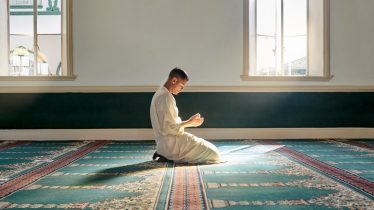 Muslim pray, hope or hands in prayer on carpet for peace, gratitude or support to Allah in holy temple or mosque. Trust, Islamic or spiritual person praying to worship God on Ramadan Kareem in Qatar.