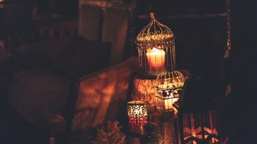 A cozy indoor scene with glowing lanterns and candles, perfect for creating ambiance.
